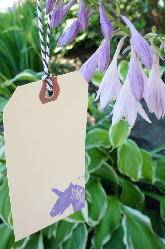printed card hanging from a flower